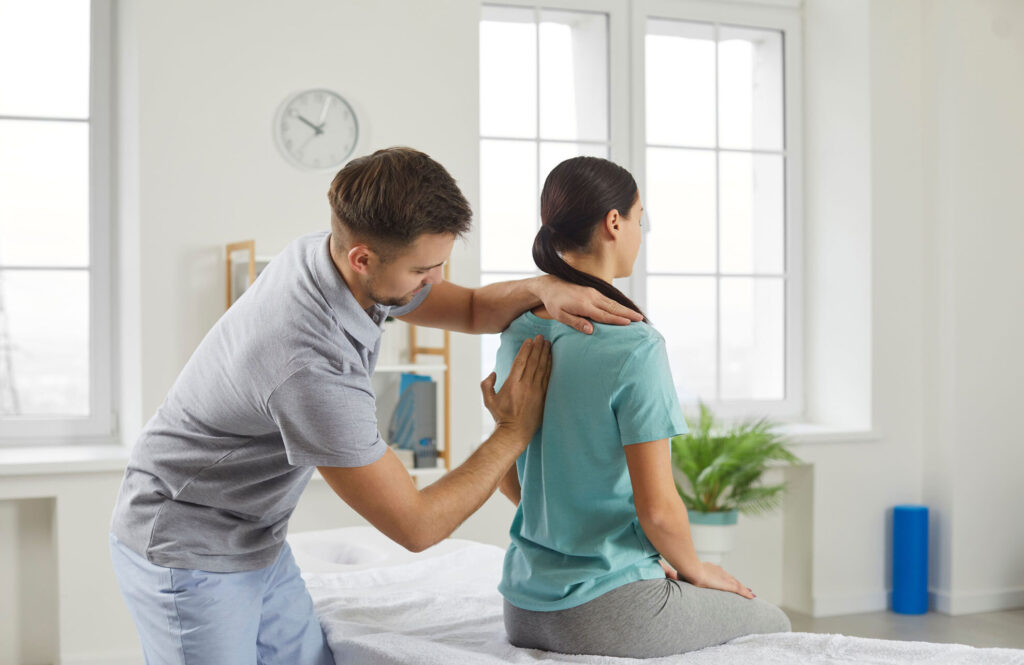 chiropractor helping client with posture